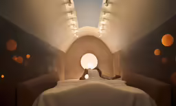 there is a woman taking a photograph in a bed
