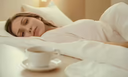 the woman is laying down on her bed with her eyes closed