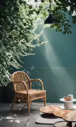 a wicker chair next to a table in a room