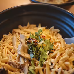 a large bowl filled with pasta and vegetables