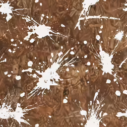 several white paint splattered onto brown ground