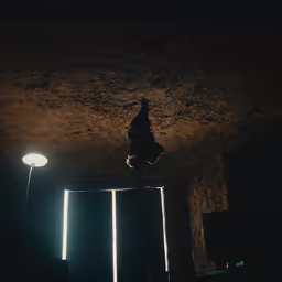 a man sitting in a doorway looking up