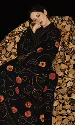 a person that is laying on rocks wearing a black dress