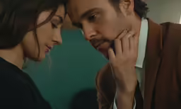 a man and woman are staring at each other