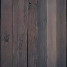 a black bird standing on top of wooden floors