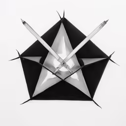 a clock made from metal pieces on a white surface