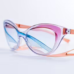the front of a pair of glasses with pink, blue and purple details