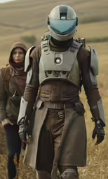 two people wearing uniforms walk in a field
