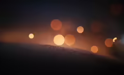 some lights and a dirt road with cars