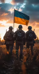 four people wearing uniforms and carrying backpacks are walking away from the camera with a flag on their shoulders