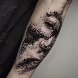 a man with an artistic tattoo on his arm