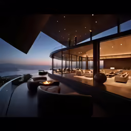 modern home with glass walls overlooking water and mountains
