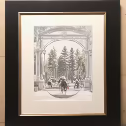 the frame is holding a photograph of a woman on a bicycle