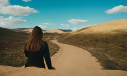 a person is walking up a dirt road