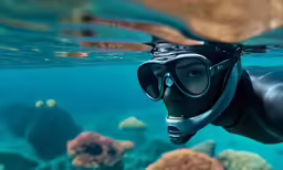 the view from under water of a man wearing a diving gear