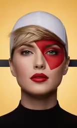 woman in red and white makeup with black eyebrows