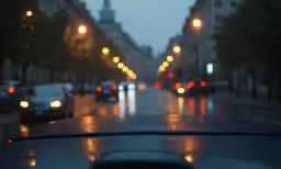 a car is driving down the street at night