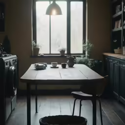 there is a small table and chair in the kitchen