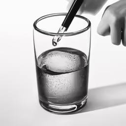 someone is cutting their knife into a glass of water