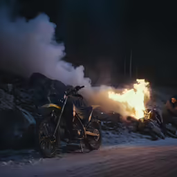 two motorcycles are sitting on the road near the flames