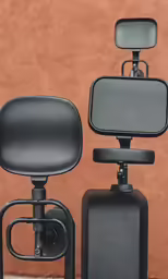 two black reclining chairs and one with a large mirror