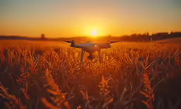 the camera attached to the blade of a small aircraft is shown in front of a sunset