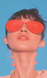 a woman with sunglasses on and a light blue background