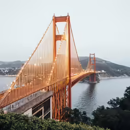 a bridge on the water has lights on it