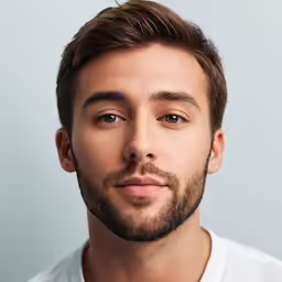 a close - up of a man wearing a beard and white t - shirt