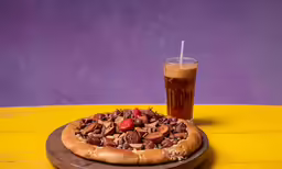 a pizza with nuts, strawberries and a beverage