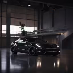 the front end of a black car sitting in an empty warehouse
