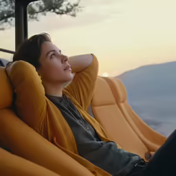 the woman is relaxing on the orange couch