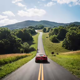 a long road has two cars driving on one side