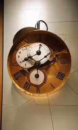 an image of an antique clock that is hanging on the wall