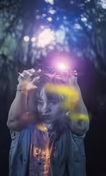 woman with light shining from her eye behind her