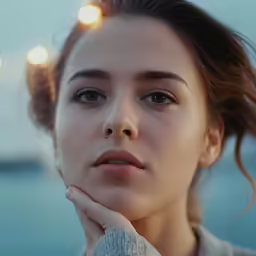 an image of a woman holding her hands in her chin