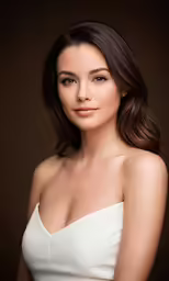 a beautiful woman wearing a strapless dress poses for the camera