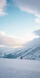 a person walking up a snow covered hill