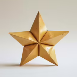 an origami style paper star on a light background
