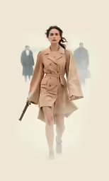 a woman in an elegant trench coat walks down the snow