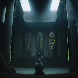 a person is sitting down in the dark