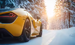 the tail end of a yellow sports car traveling down a road