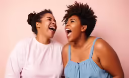 two black woman posing for a picture together with their mouths wide open