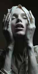 the woman is covering her eyes with both hands