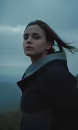 a young lady with a gray scarf and black jacket