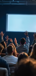 someone is raising their hands to a presentation on a screen