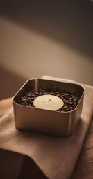 a metal container filled with lots of chocolate beans