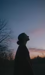 a person with their eyes closed and watching the sun rise
