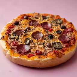 a pizza with toppings and topping on a table
