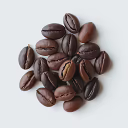 coffee beans are scattered over a table top